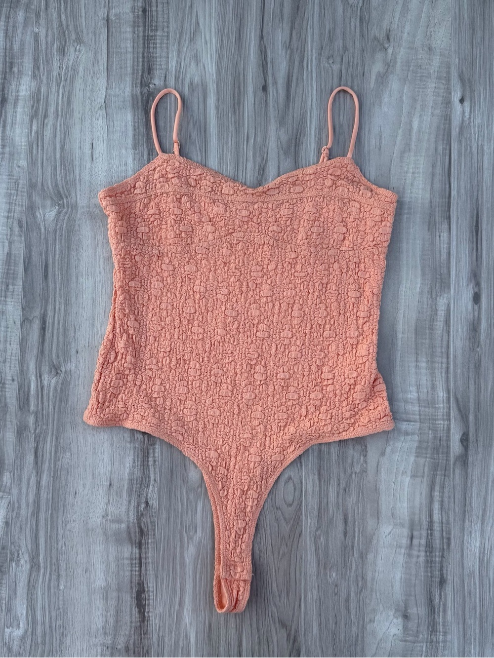 Elodie bodysuit features a distinctive textured lace material